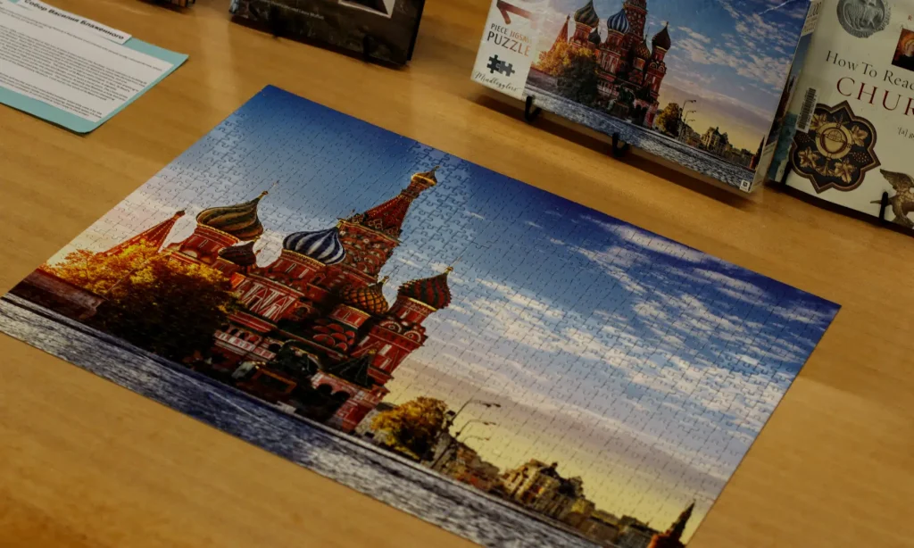 Laying complete on the table, is a 1000-piece puzzle of Cathedral of the Intercession of Most Holy Theotokos on the Moat